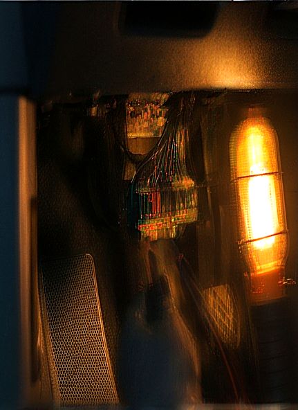 Vehicle wiring being inspected under a work lamp
