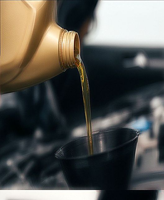 Fresh oil being poured into a funnel